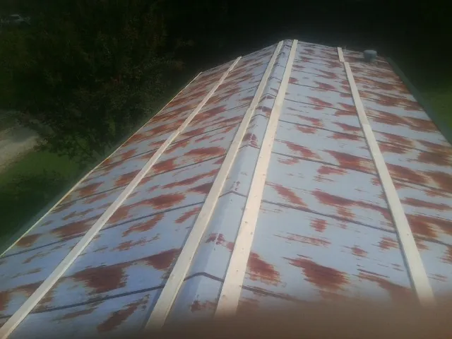 Rusted metal roof panels with new wood purlins before replacement — Storm Damage Roof Repair in Labelle by Roofing Brothers